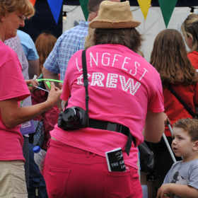 Lingfest crew in hi-vis tshirts fitting wristbands